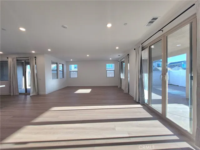 an empty room with windows and closet