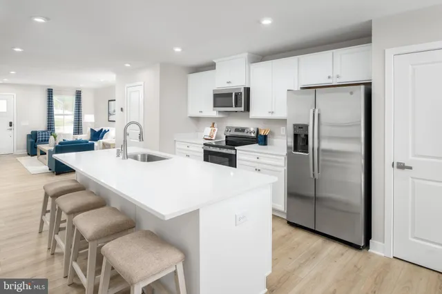 a kitchen with stainless steel appliances a refrigerator stove microwave and cabinets