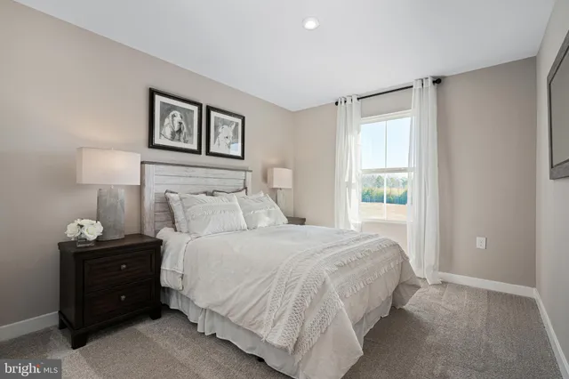 a bedroom with a bed and a night stand