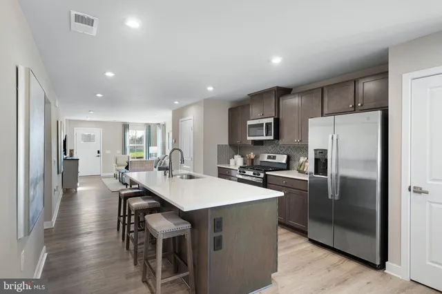 a kitchen with refrigerator cabinets dining table and chairs