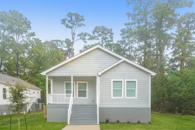 a view of a house with yard and a garden