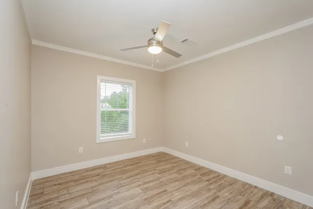 wooden floor in an empty room with a window