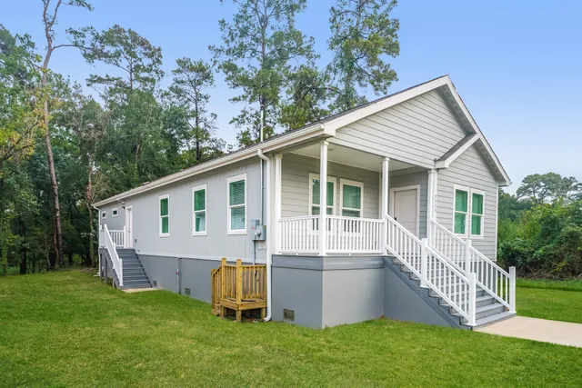 a view of a house with a backyard and stairs