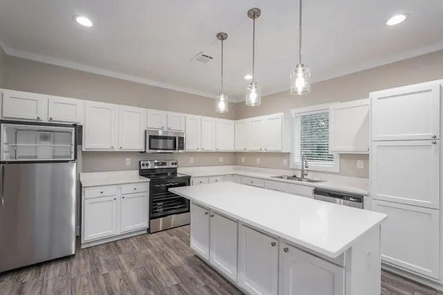 a kitchen with a sink stainless steel appliances and cabinets