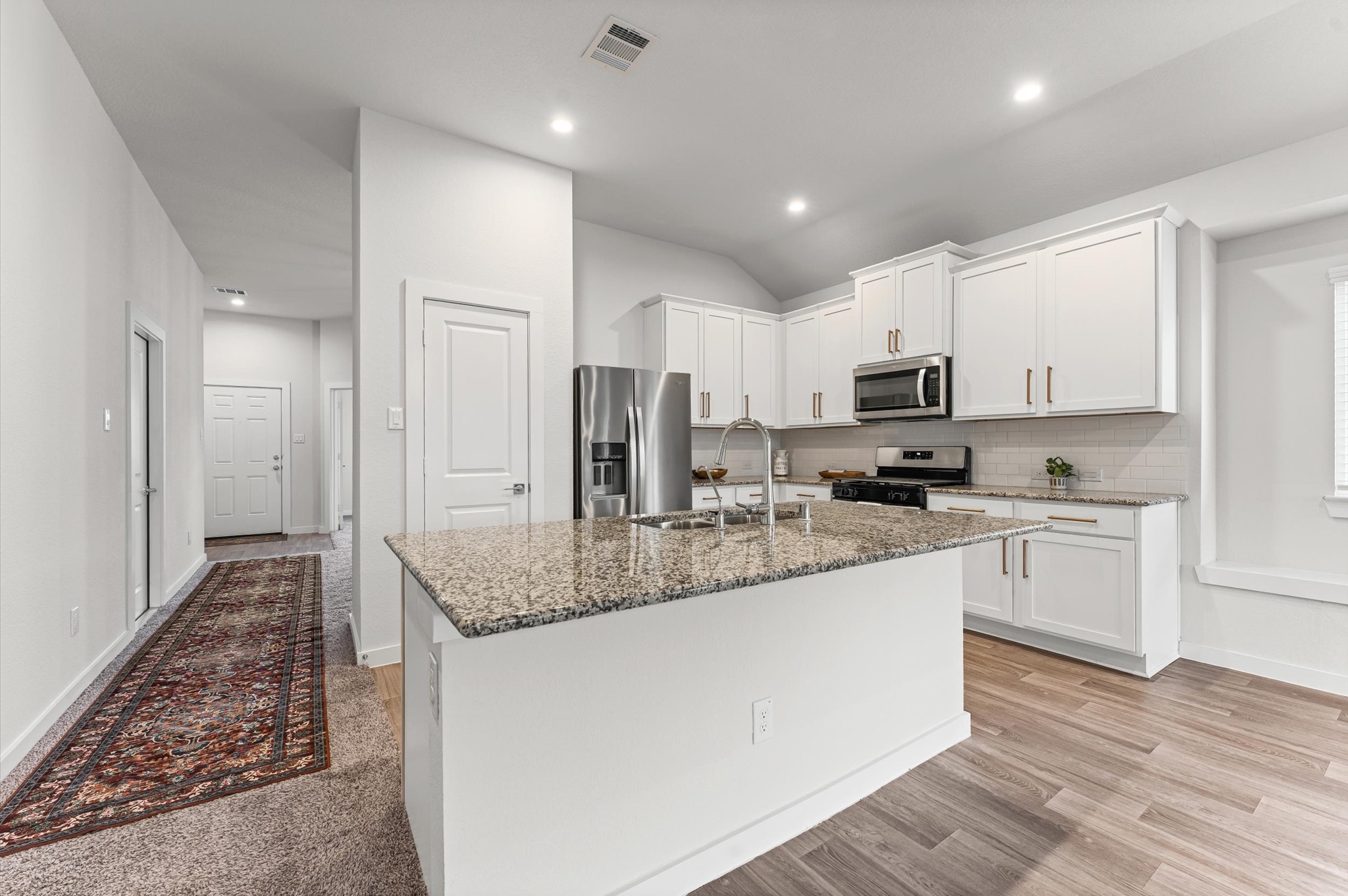 21431 Indigo Ruth Drive Spring, TX 77379 - Photo 4 of 19 a kitchen with stainless steel appliances granite countertop a sink refrigerator and cabinets