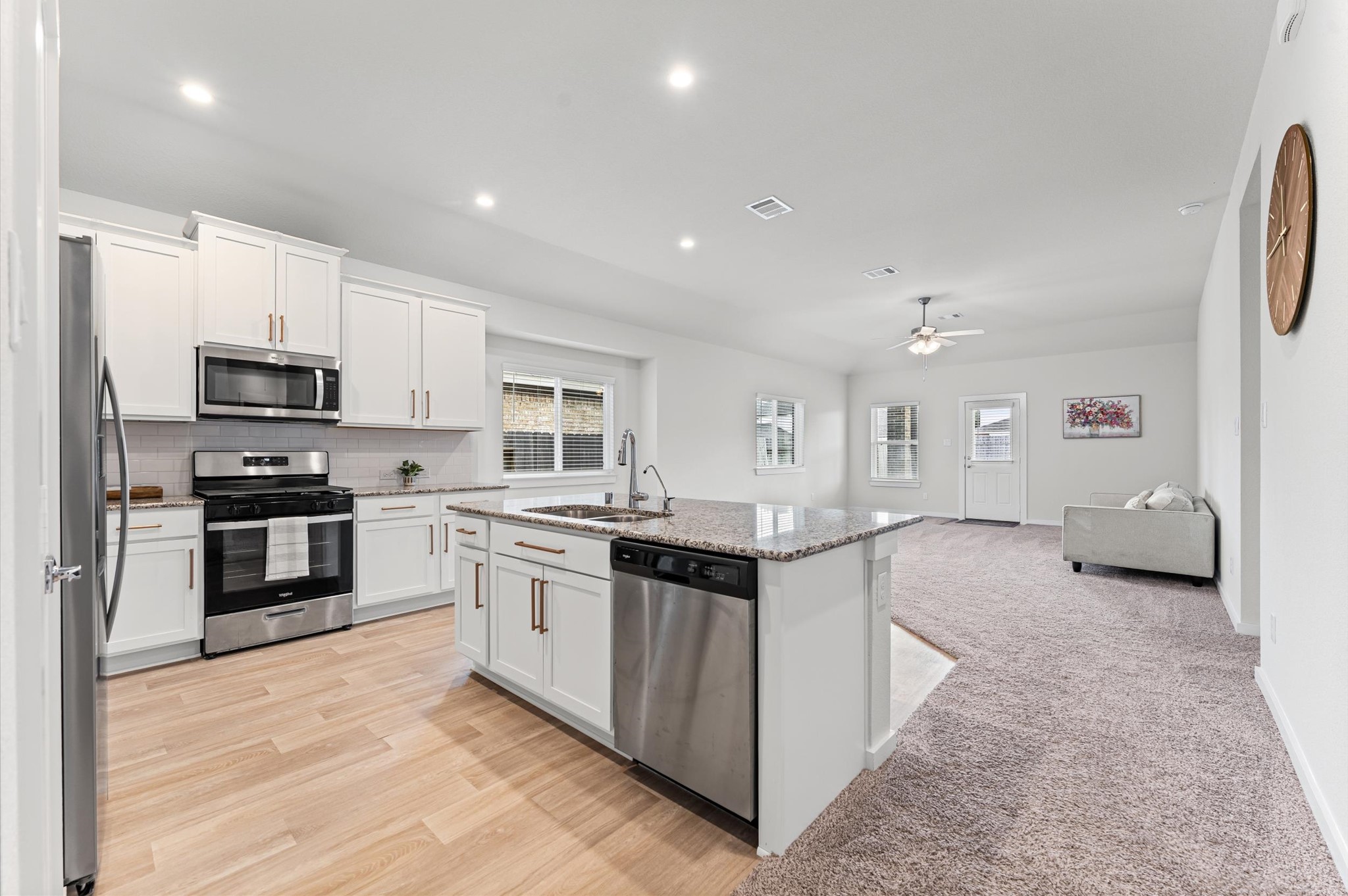 21431 Indigo Ruth Drive Spring, TX 77379 - Photo 6 of 19 a kitchen with stainless steel appliances granite countertop a stove and a sink