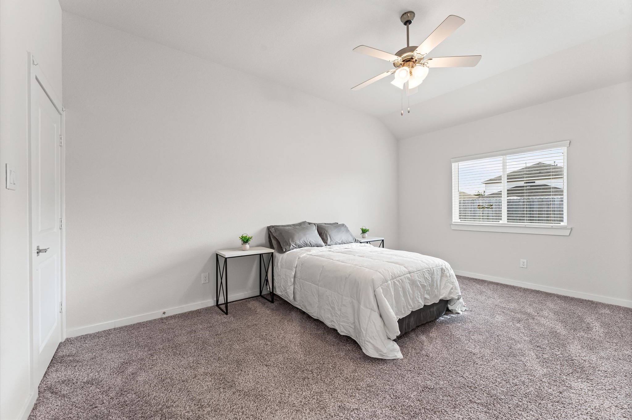 21431 Indigo Ruth Drive Spring, TX 77379 - Photo 10 of 19 a bedroom with a bed chandelier and a window
