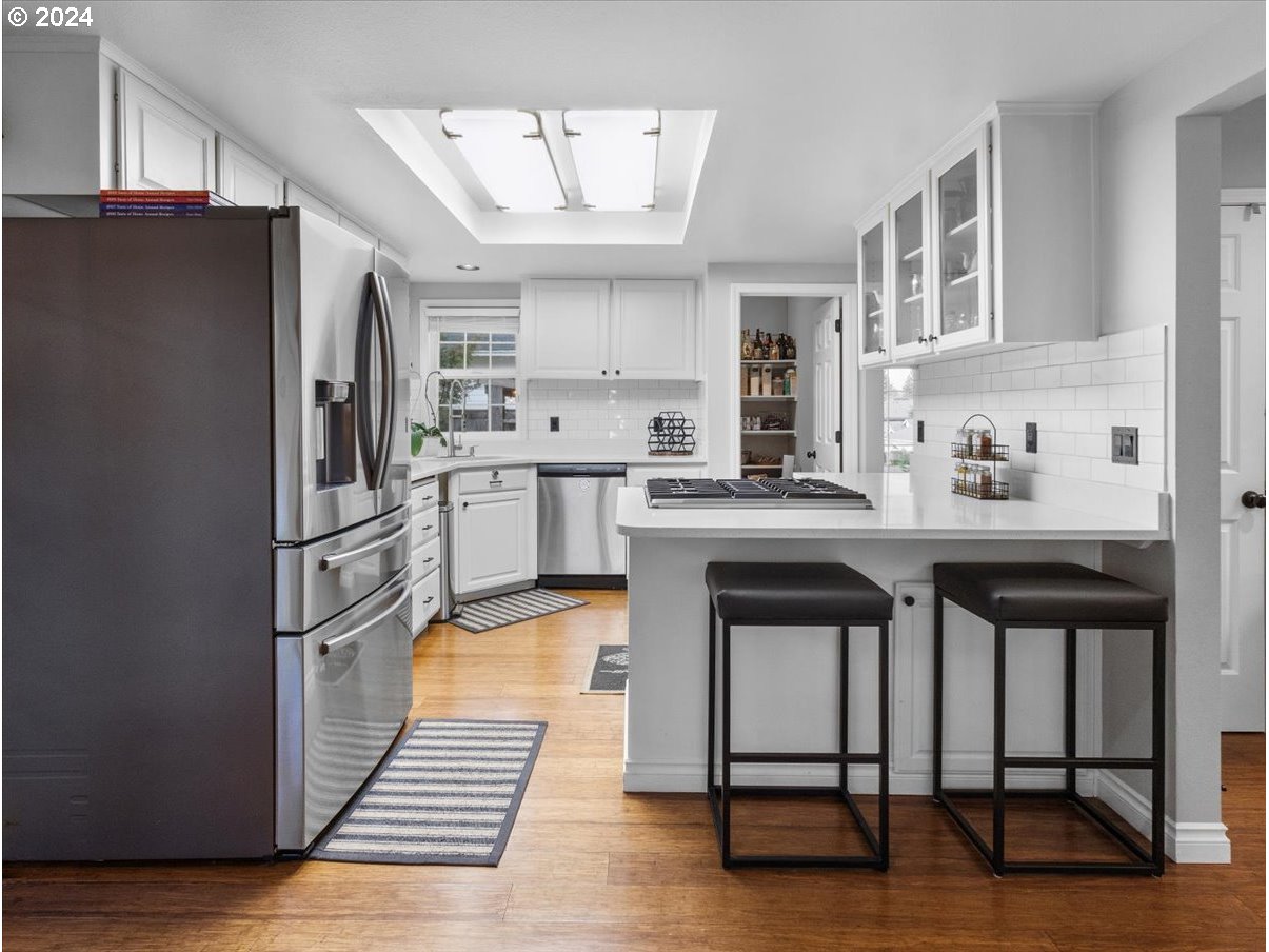 1990 Southwest Willow Parkway Gresham, OR 97080 - Photo 12 of 46 a kitchen with stainless steel appliances granite countertop a sink stove and refrigerator