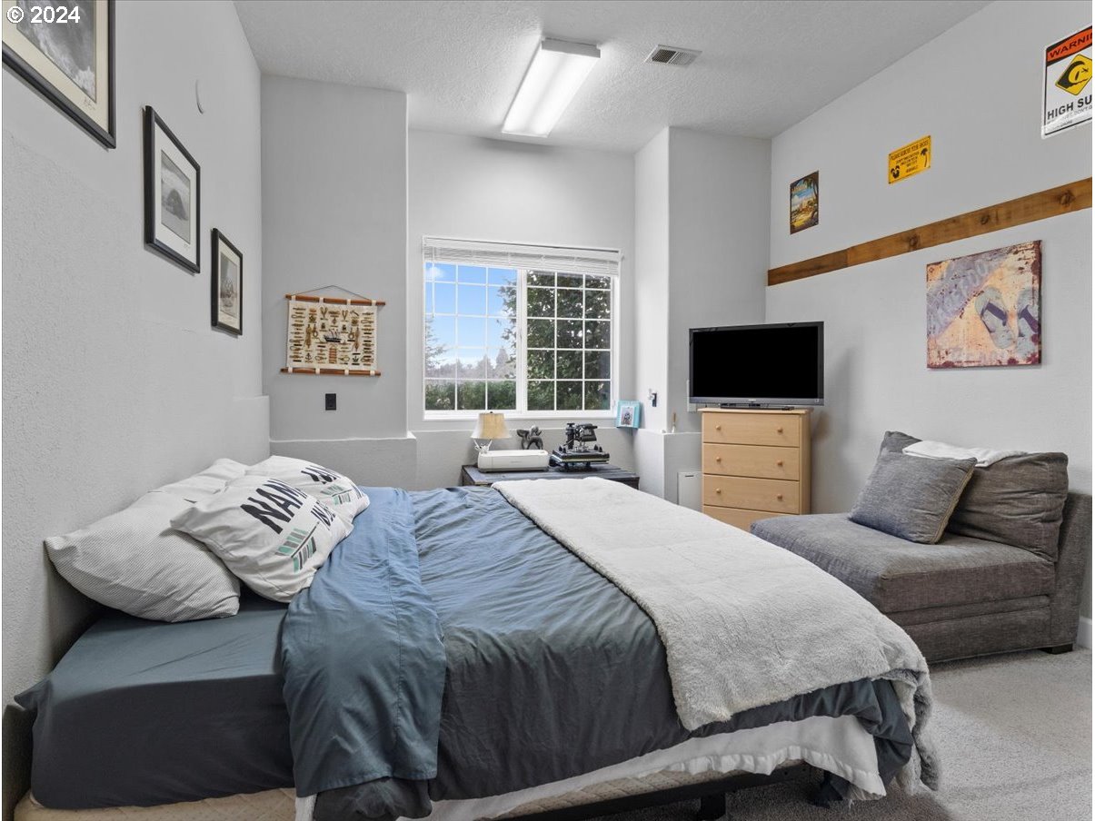 1990 Southwest Willow Parkway Gresham, OR 97080 - Photo 20 of 46 a bedroom with a bed and a flat screen tv