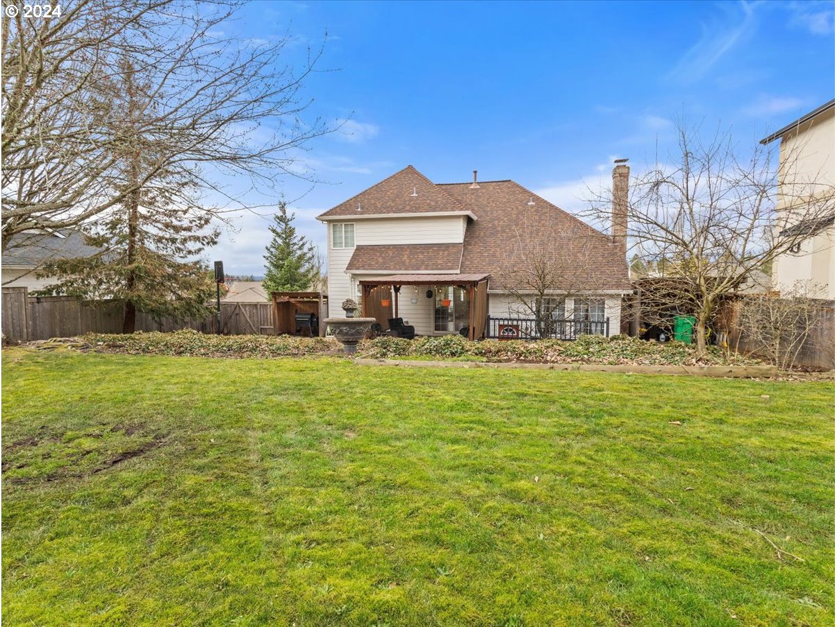 1990 Southwest Willow Parkway Gresham, OR 97080 - Photo 37 of 46 a front view of a house with a yard table and chairs