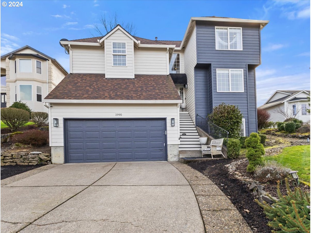 1990 Southwest Willow Parkway Gresham, OR 97080 - Photo 4 of 46 a front view of a house with a yard and garage