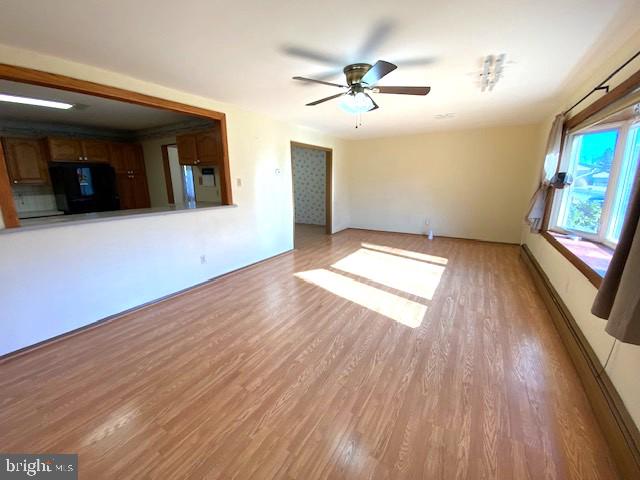 7501 Spring Creek Road Macungie, PA 18062 - Photo 2 of 16 a view of empty room with wooden floor and fan