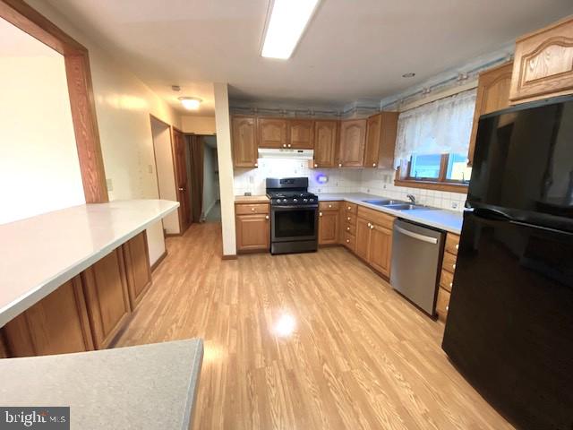 7501 Spring Creek Road Macungie, PA 18062 - Photo 5 of 16 a kitchen with a sink wooden floor and stainless steel appliances