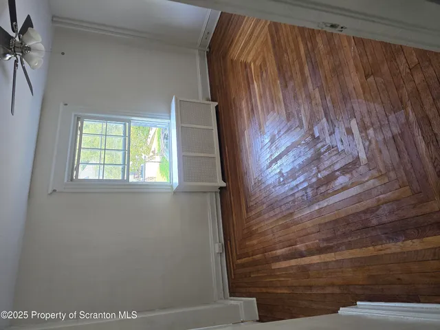 a view of staircase with white walls and a window
