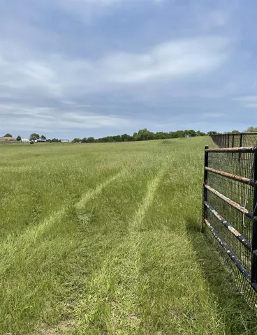 a view of a field with an ocean view