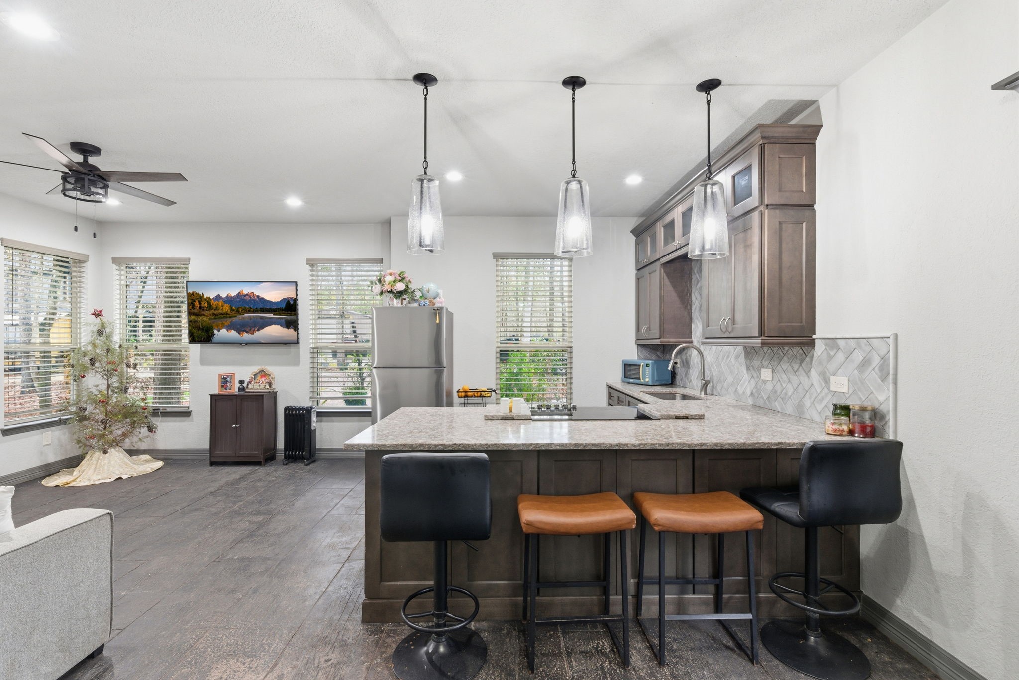1480 Traylor Road Conroe, TX 77304 - Photo 21 of 25 a kitchen with stainless steel appliances kitchen island granite countertop a sink and cabinets