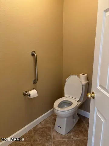 a bathroom with a double vanity sink toilet mirror and shower