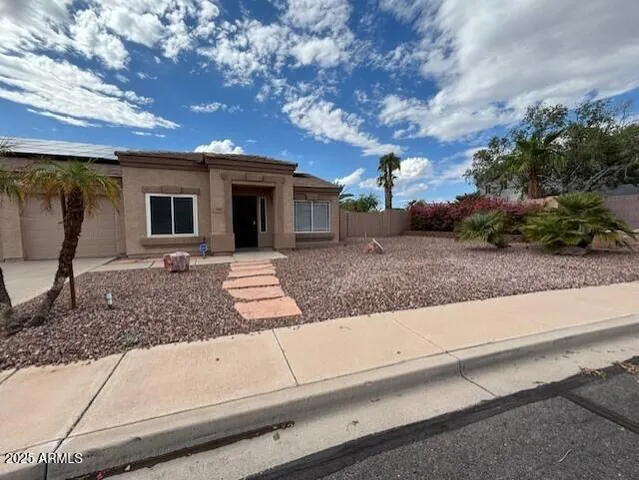 a view of a house with a backyard