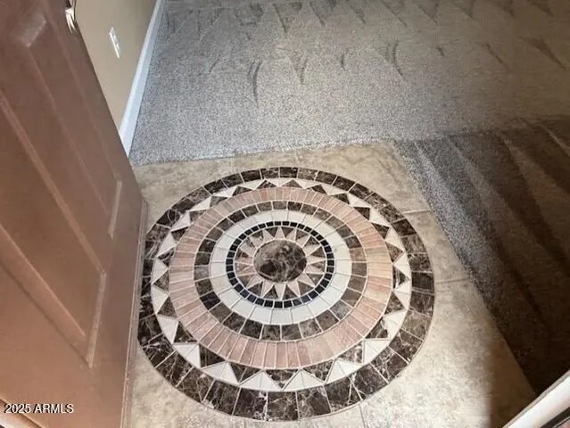 a kitchen with kitchen island granite countertop a stove top oven a sink a counter top space and cabinets