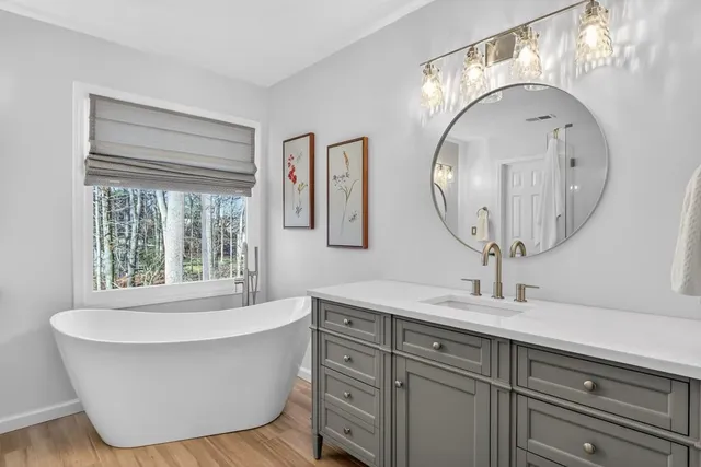 a bathroom with a bathtub and a mirror