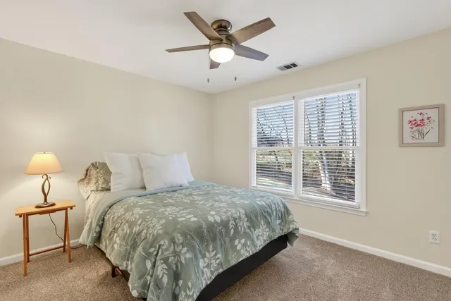 a bed room with a bed and a chandelier