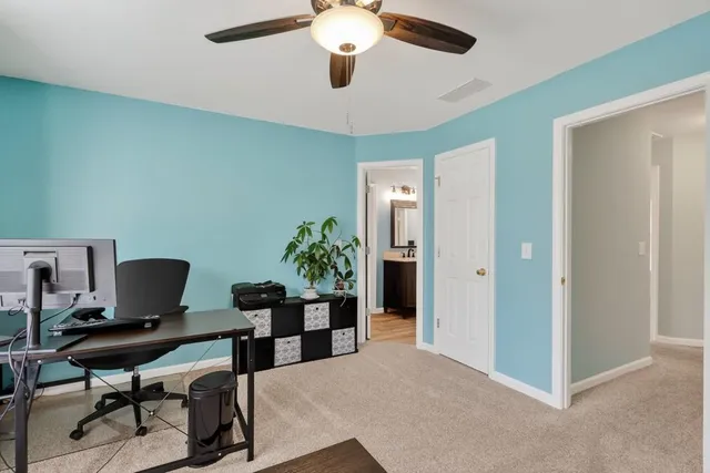 a workspace with furniture and a potted plant