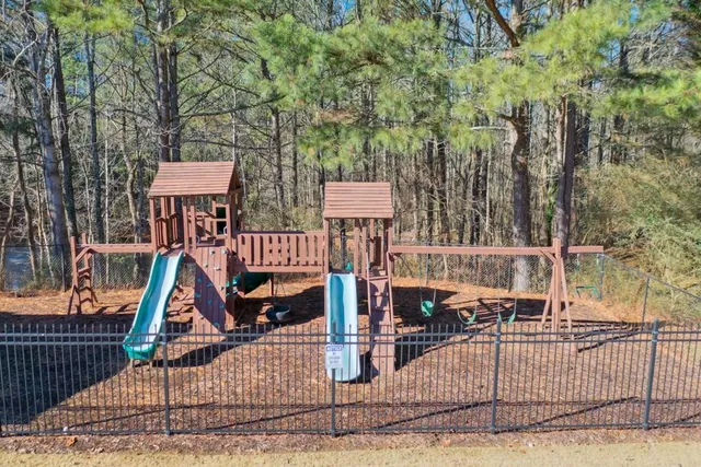 a sign board with tall trees