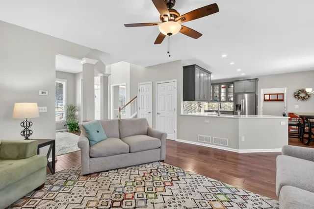 a living room with furniture and kitchen view