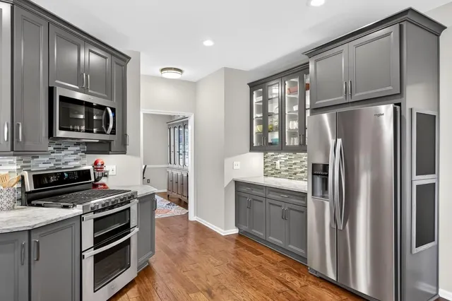 a kitchen with a refrigerator stove and microwave