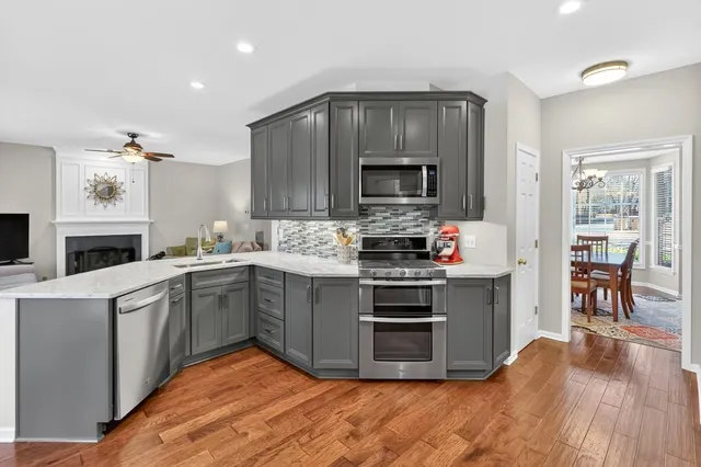 a kitchen with stainless steel appliances a stove a sink and a microwave
