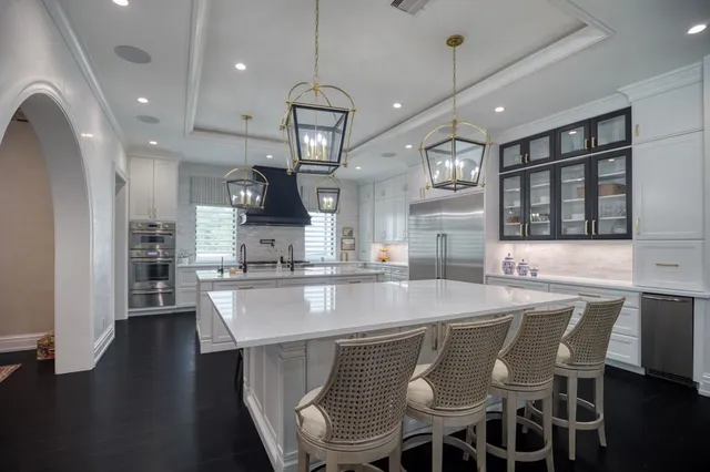 a large kitchen with a table and chairs