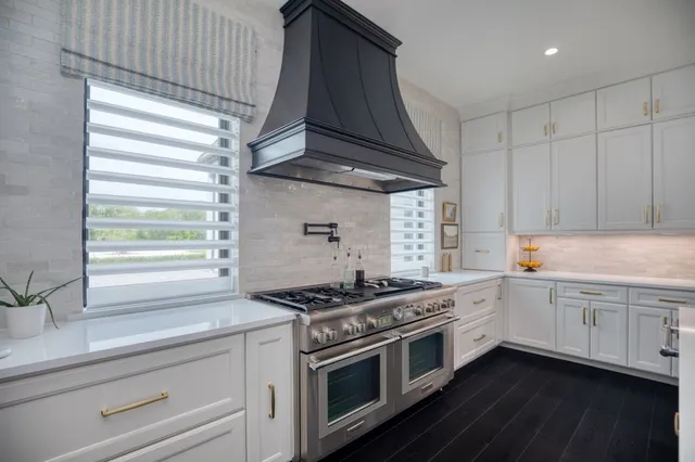 a kitchen with stainless steel appliances white cabinets and a stove