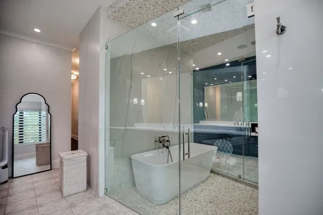 a bathroom with a bathtub shower and toilet