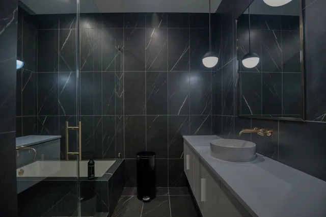 a bathroom with a sink and mirror