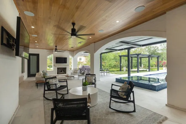 a living room with fireplace furniture and a large window