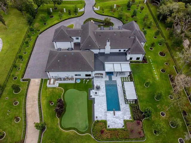an aerial view of a house with a swimming pool