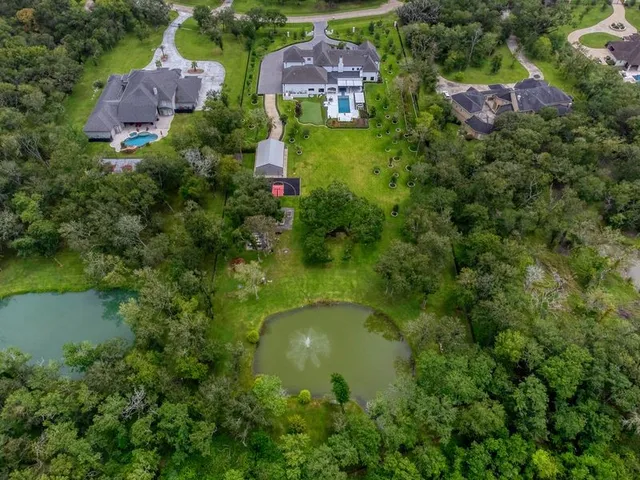 an aerial view of residential house with pool and outdoor space
