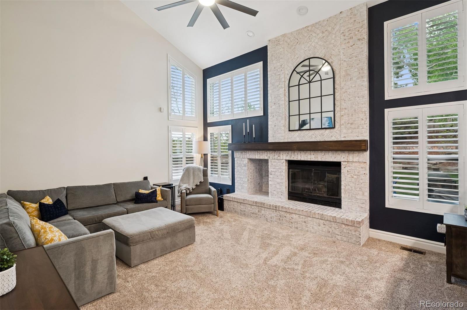 2187 Wynterbrook Drive Highlands Ranch, CO 80126 - Photo 15 of 41 a living room with furniture and a fireplace
