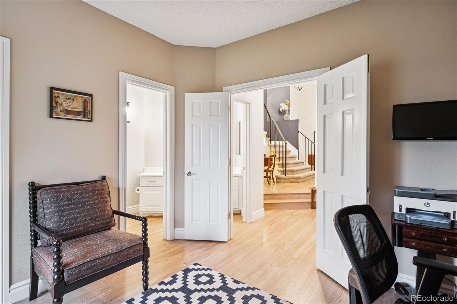 2187 Wynterbrook Drive Highlands Ranch, CO 80126 - Photo 17 of 41 a hallway with furniture and a flat screen tv