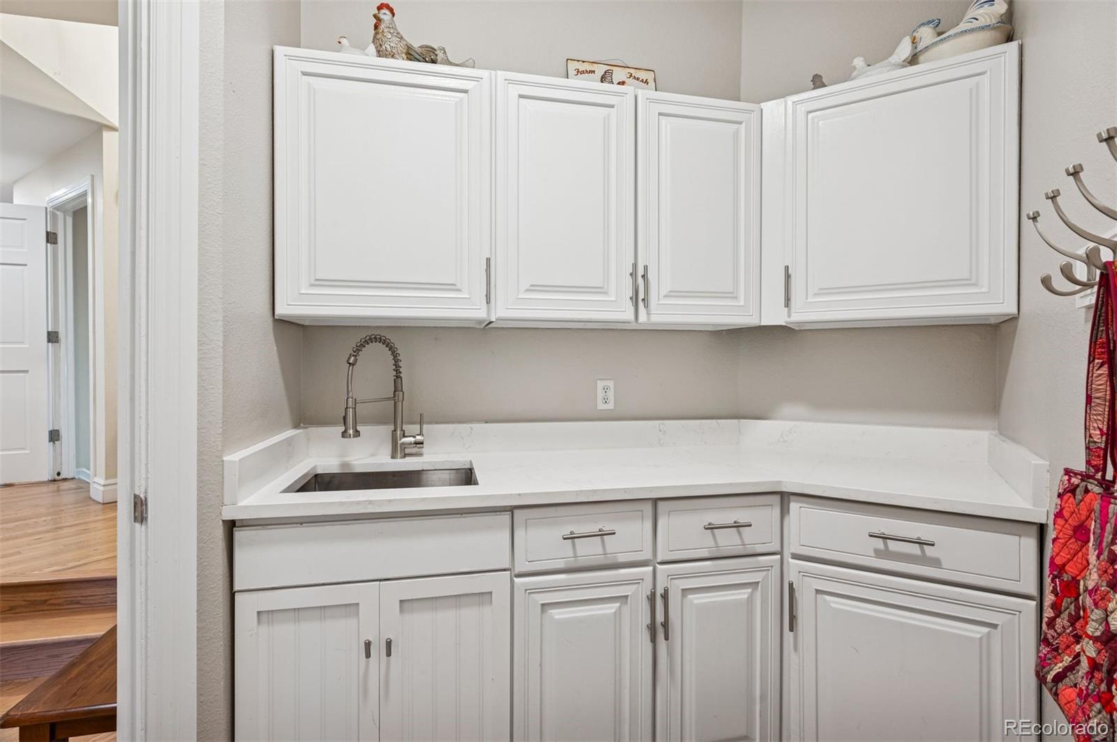 2187 Wynterbrook Drive Highlands Ranch, CO 80126 - Photo 20 of 41 a kitchen with stainless steel appliances granite countertop white cabinets sink and dishwasher