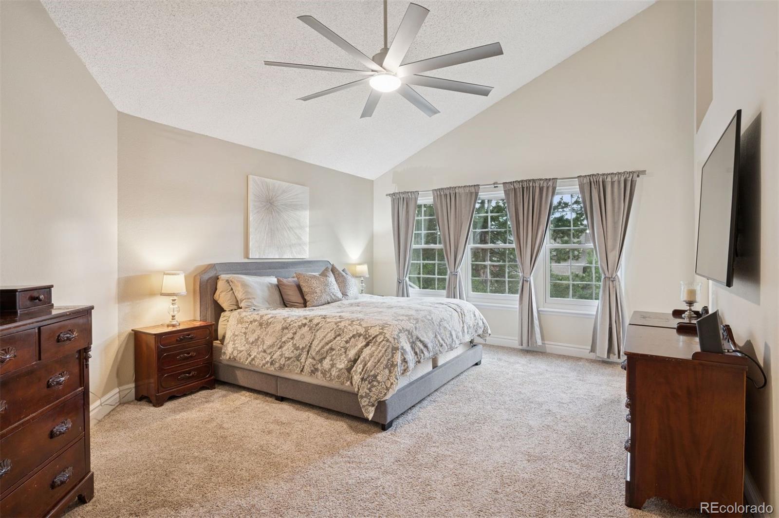 2187 Wynterbrook Drive Highlands Ranch, CO 80126 - Photo 21 of 41 a spacious bedroom with a bed and glass window