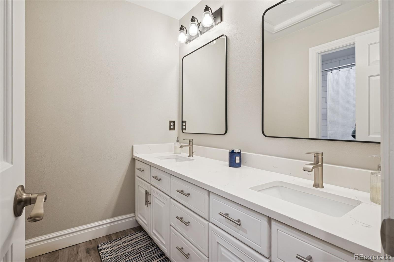 2187 Wynterbrook Drive Highlands Ranch, CO 80126 - Photo 27 of 41 a bathroom with double vanity sink and a mirror