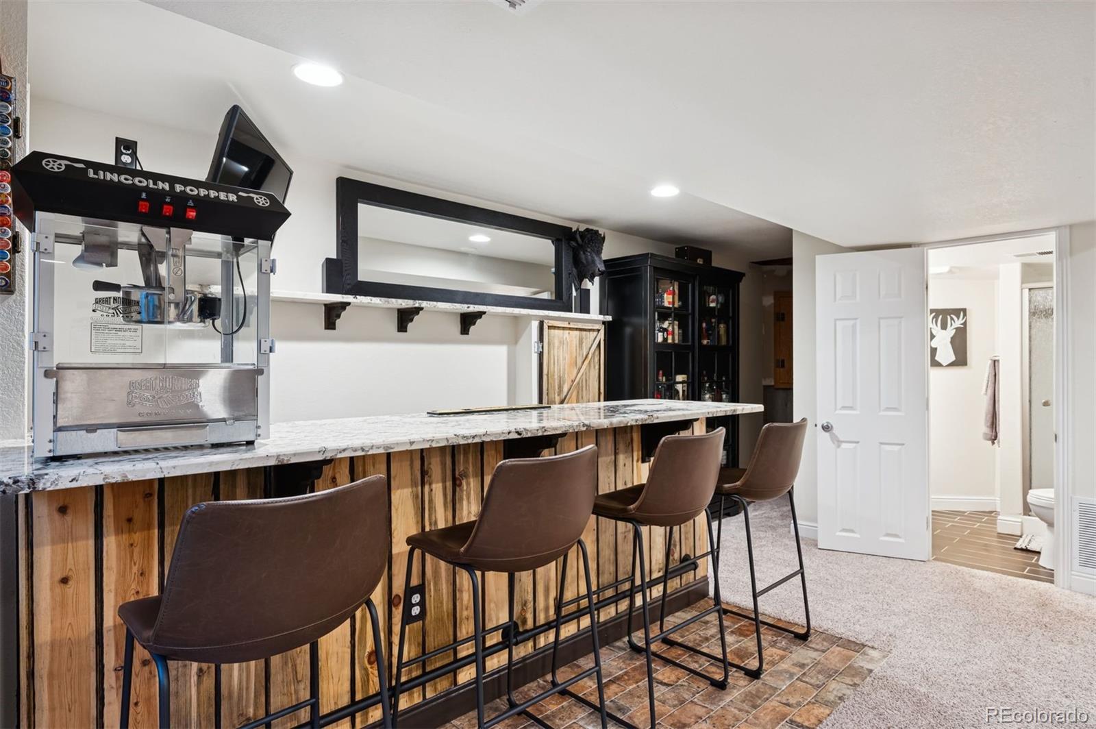 2187 Wynterbrook Drive Highlands Ranch, CO 80126 - Photo 29 of 41 a kitchen with stainless steel appliances granite countertop a table chairs sink and cabinets