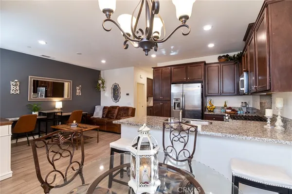 a kitchen with granite countertop stainless steel appliances and wooden cabinets
