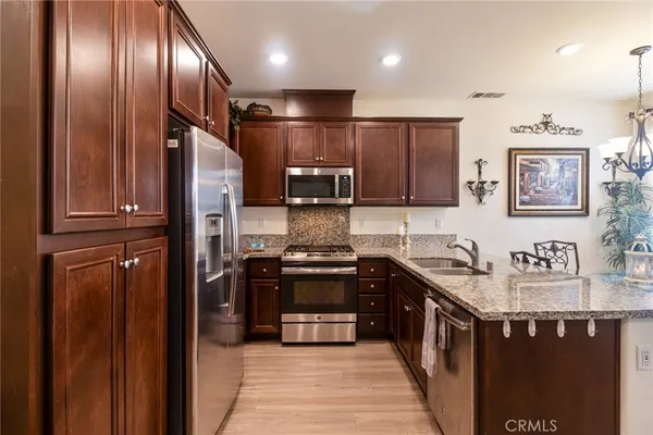 a kitchen with a refrigerator sink and microwave