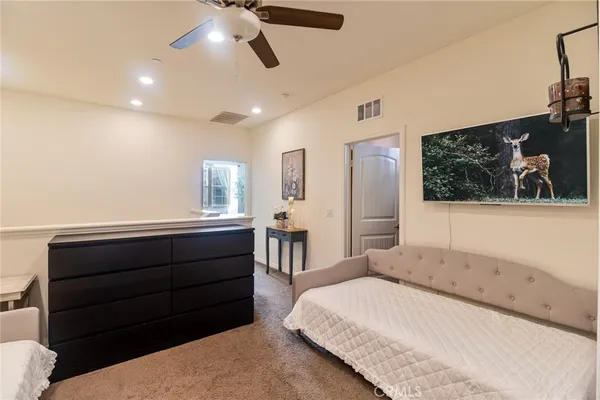 a view of a living room and bedroom