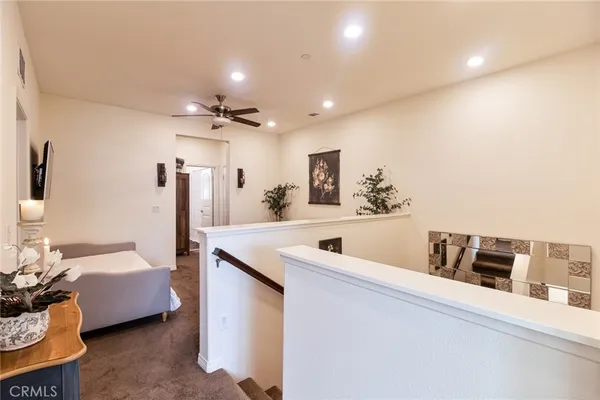 a bathroom with a granite countertop sink and a toilet