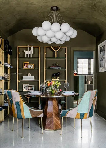 a view of a dining room with furniture and chandelier