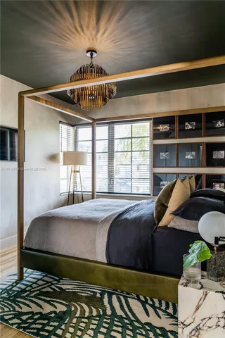 a bedroom with bed and window