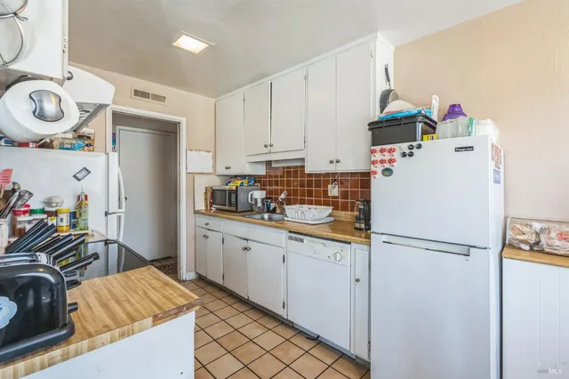 a kitchen with a refrigerator and a sink
